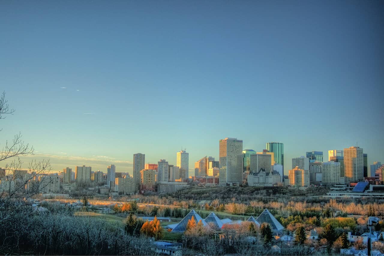 Downtown Edmonton skyline over the river valley and Muttart Conservatory at golden hour