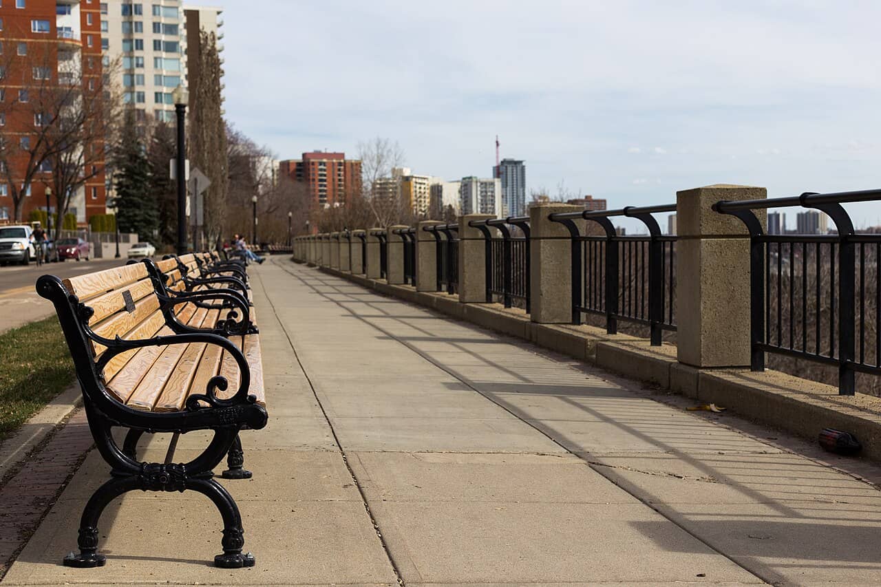 Benches along Victoria Promenade with downtown Edmonton towers beyond
